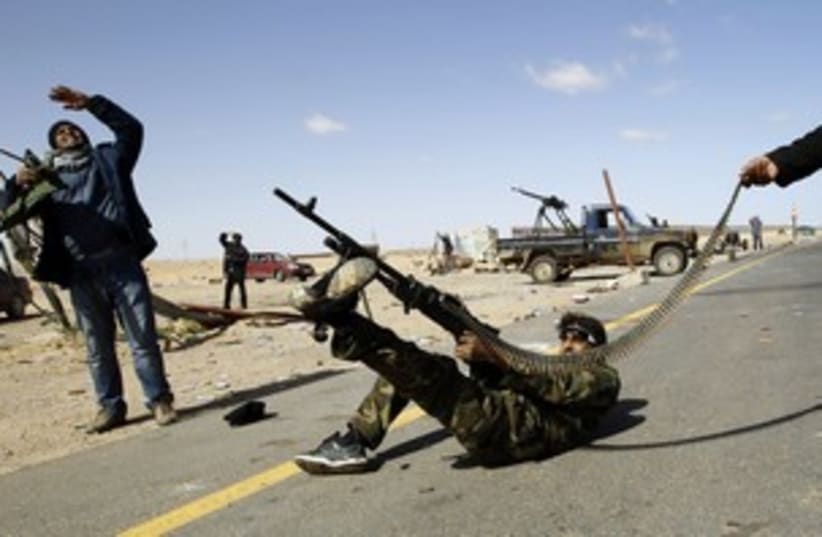Libyan rebel firing at heli (R) 311 (photo credit: Goran Tomasevic / Reuters)