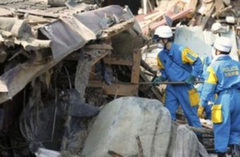 Rescue workers searching through rubble in Japan 311 R (photo credit: REUTERS/Lee Jae-Won)