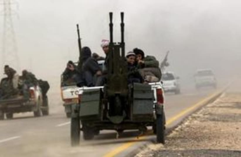 Libyan rebels fleeing 311 (R) (photo credit: REUTERS/Goran Tomasevic)