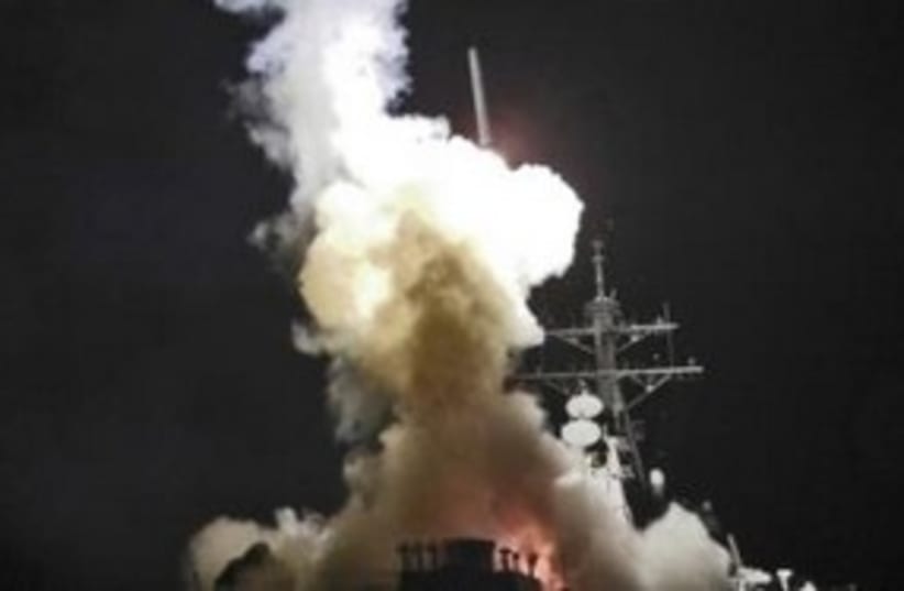 Tomahawk missile being fired from USS Barry 311 (R) (photo credit: REUTERS/Roderick Eubanks/US Navy photo)