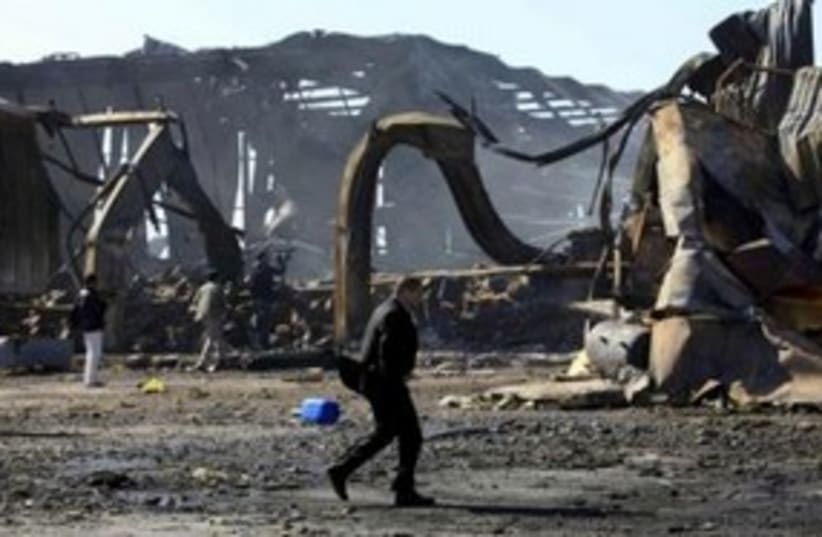 Libyanat naval facility damaged by air strikes 311 R (photo credit: REUTERS/Ahmed Jadallah)