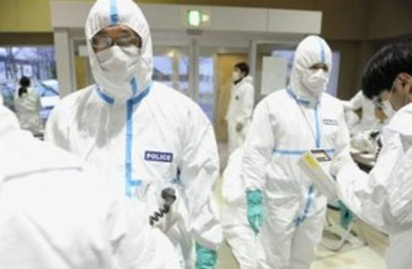 Japanese police after radiation screening 311 (R) (photo credit: REUTERS/Kyodo)