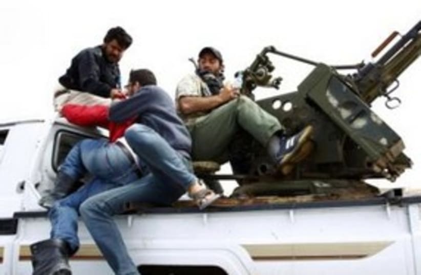 Libyan rebels with anti-aircraft gun 311 (R) (photo credit: REUTERS/Andrew Winning)