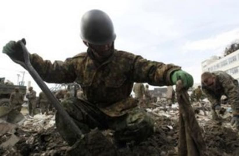 Japanese soldier searches for bodies 311 (R) (photo credit: REUTERS/Kim Kyung-Hoon)