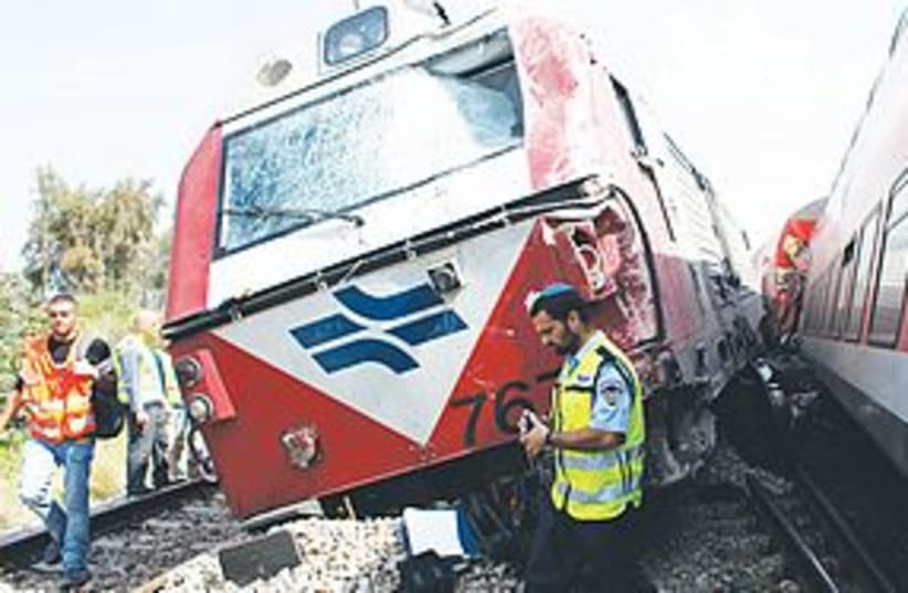 israel railways 311POLICE AND RESCUE workers survey the scen (photo credit: Nir Elias/Reuters)