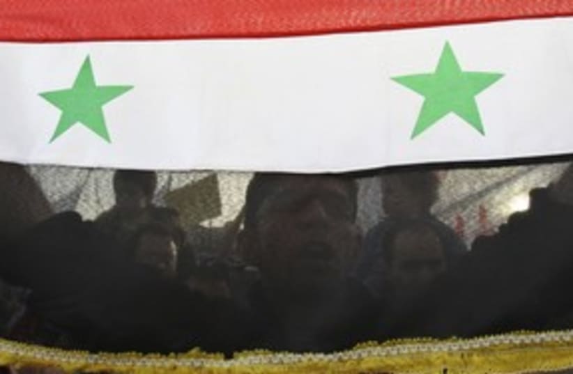 syrian flag and protester_311 reuters (photo credit: Muhammad Hamed / Reuters)