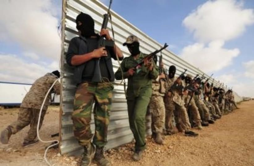 Libyan rebels with guns 311 (r) (photo credit: REUTERS/Esam al-Fetori)