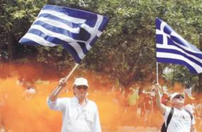Greece protesters flags 311 (R) (photo credit: Yiorgos Karahalis/Reuters)