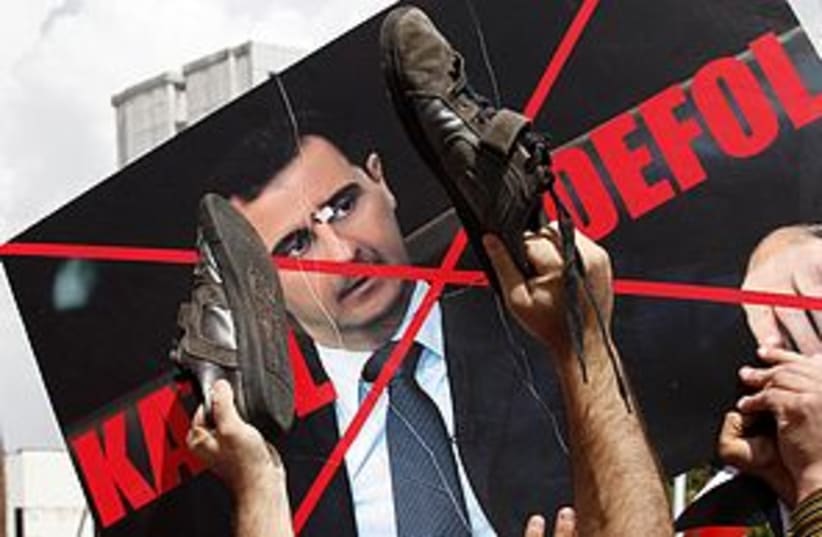 Defaced Syria Assad Poster 311 (photo credit: REUTERS)