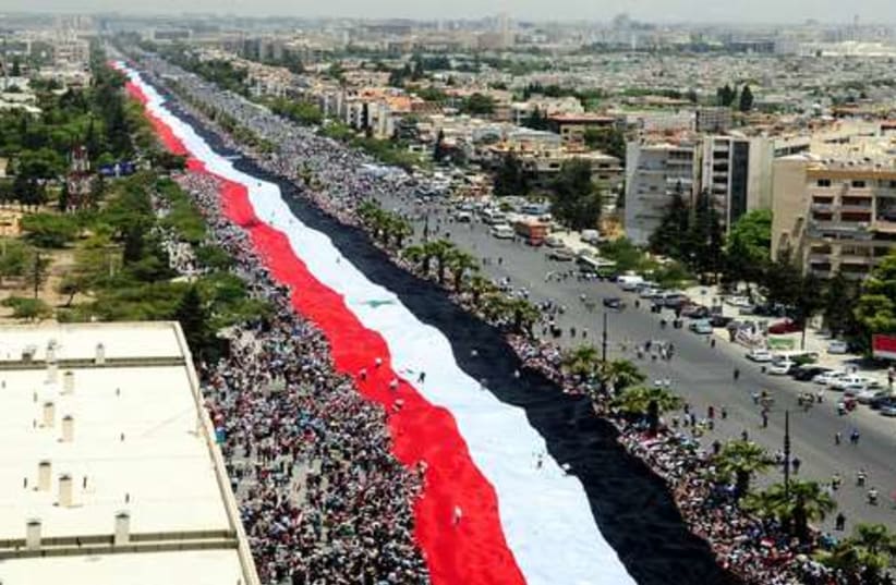 Syria flag demonstration 521 (photo credit: REUTERS/Sana Sana)