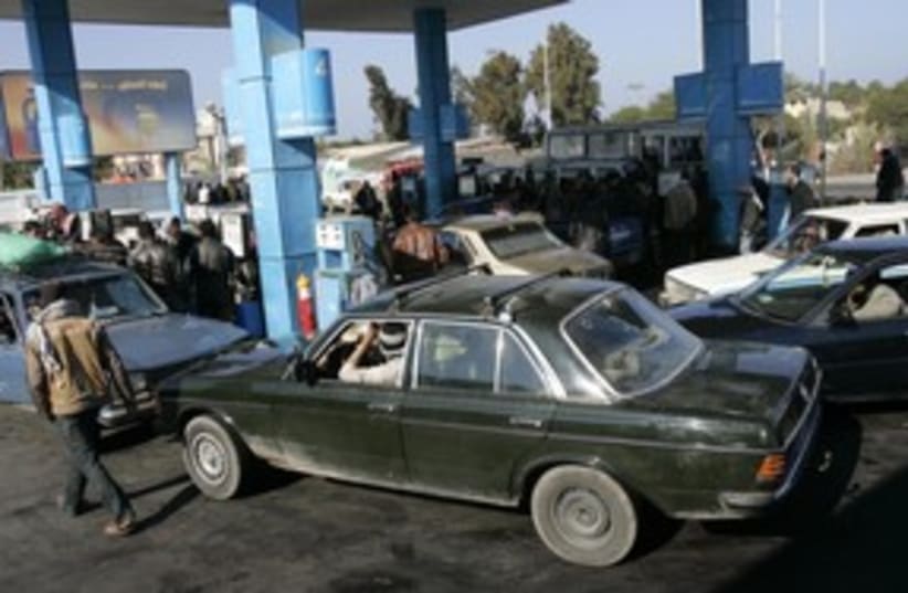Gazans buy gasoline in Rafah 311 (R) (photo credit: Nasser Nuri / Reuters)