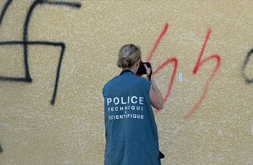 French policewoman photographs swastika 521 (photo credit: REUTERS)