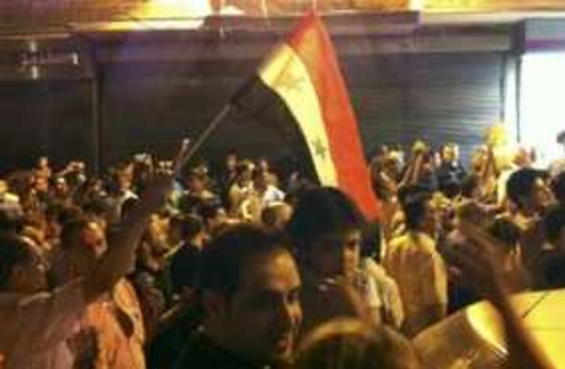 Syria protests at night with flag 311 (photo credit: REUTERS/Handout )