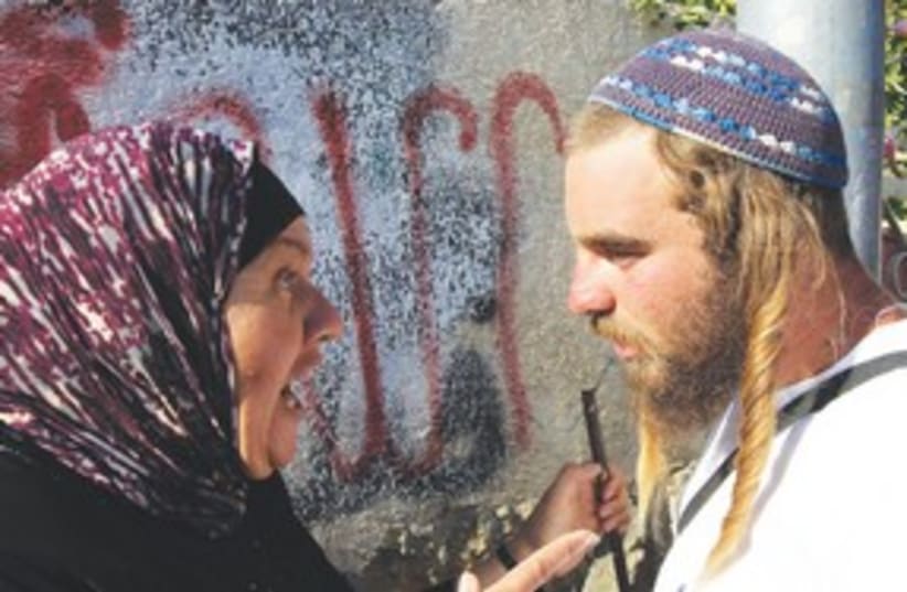 Confrontation between Palestinian woman and right wing man (photo credit: REUTERS)