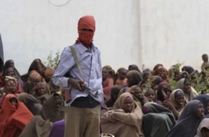 Al-Shabaab fighter at  food distribution camp Somalia 31 (R) (photo credit: Feisal Omar / Reuters)