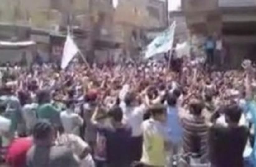 Demonstration in Syrian city of Hajar al-Aswad 311 (R) (photo credit: REUTERS)