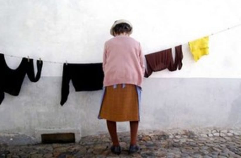 woman hanging laundry 311 (photo credit: Maxim Reider)