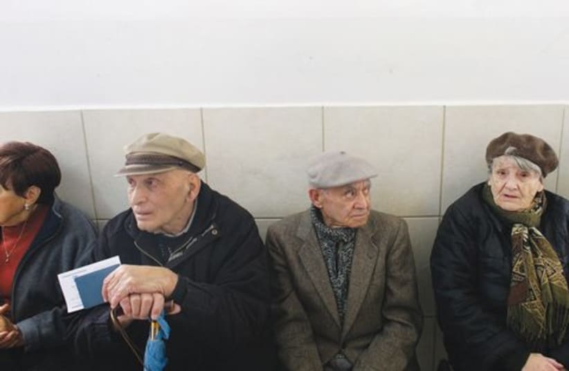 Elderly Israelis wait to vote at a polling station. (photo credit: Reuters)