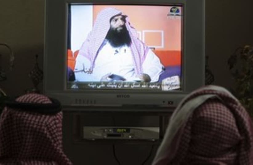 Saudis watching Ramadan television program 311 (R) (photo credit: Fahad Shadeed / Reuters)