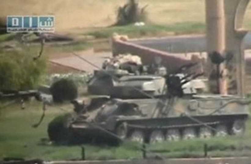 Tank sits in Hama, Syria_311 (photo credit: REUTERS)