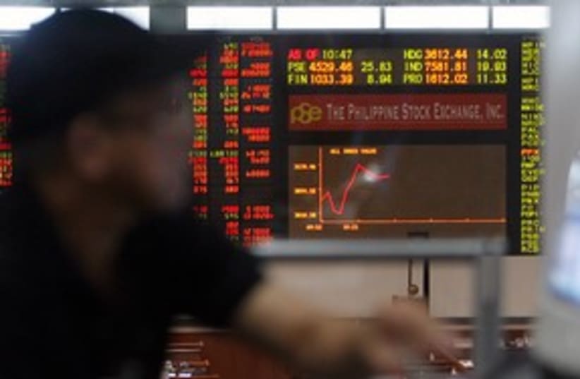 Stock trader monitors market movement 311 (R) (photo credit: REUTERS/Cheryl Ravelo)
