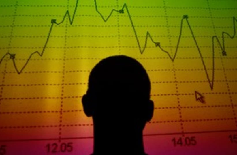 Trader looks at market graph 311 (R) (photo credit: REUTERS/Tony Gentile)