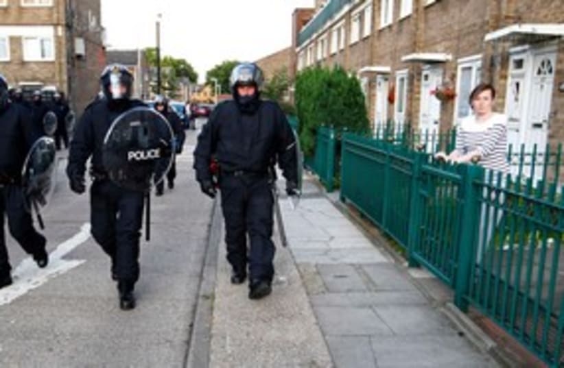 Riot police patrol through an estate in east London 311 (R) (photo credit: REUTERS/Andrew Winning )