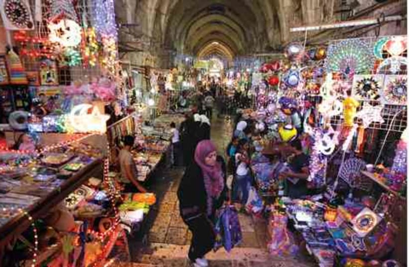 Muslims shop for Ramadan decorations in Jerusalem. (photo credit: Ammar Awad/Reuters)