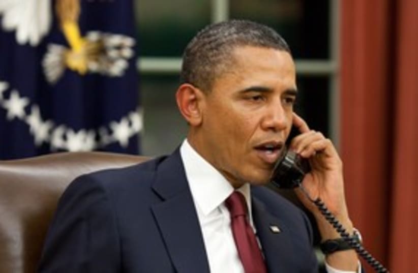 US President Barack Obama speaks on the phone 311 (R) (photo credit: Reuters / White House)