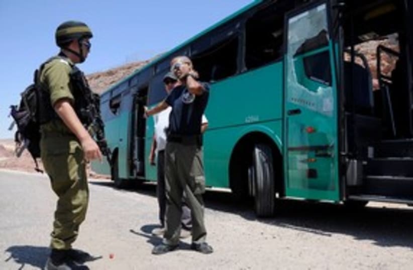 Security forces standing next to an attacked bus 311 (R) (photo credit: REUTERS/Lior Grundman)
