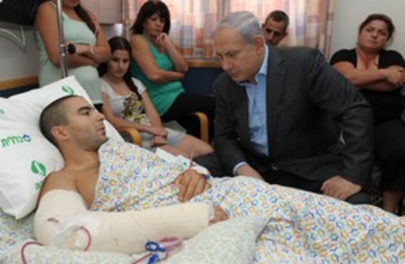 Netanyahu visits wounded soldier in hospital 311 (photo credit: Moshe Milnr / GPO)