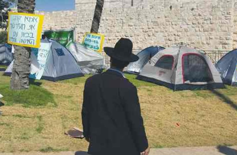 Haredi man in front of tents in Jerusalem 521 (photo credit: Reuters)