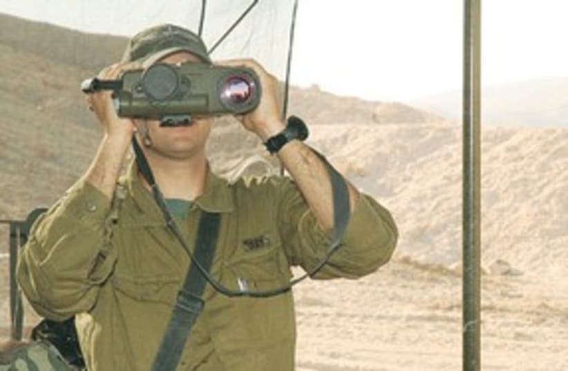 A SOLDIER looks through the Amit targeting system (photo credit: Courtesy IDF)