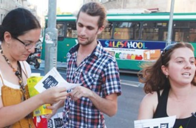 TENT CITY protesters distribute fliers in Jerusalem (photo credit: Marc Israel Sellem/The Jerusalem Post))