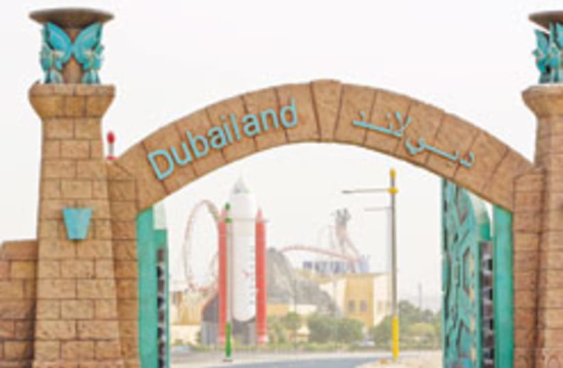 The Dubailand sales center, seen behind the gate, touts what the theme park is supposed to become, promising dinosaurs and spaceships, Spiderman and Shrek. Two live tigers prowl a glass enclosure next to the reception desk. But it is now unclear when or if much of it will ever get built. (photo credit: AP)