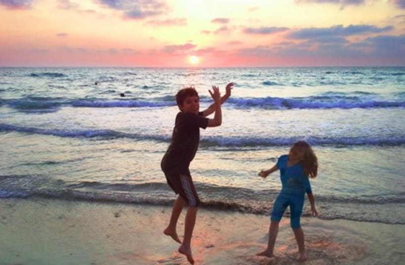 Children playing on beach at sunset 465 (photo credit: Courtesy)