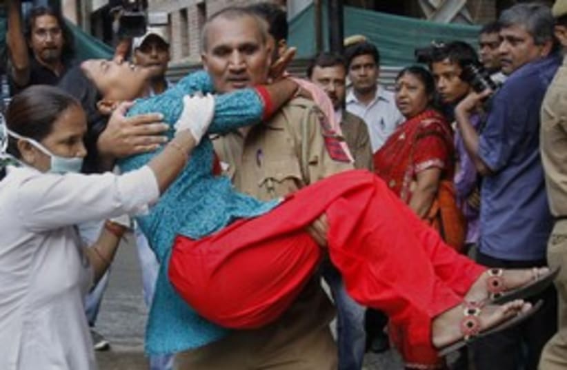 nurse carries woman from New Dehli attack_311 (photo credit: Reuters)