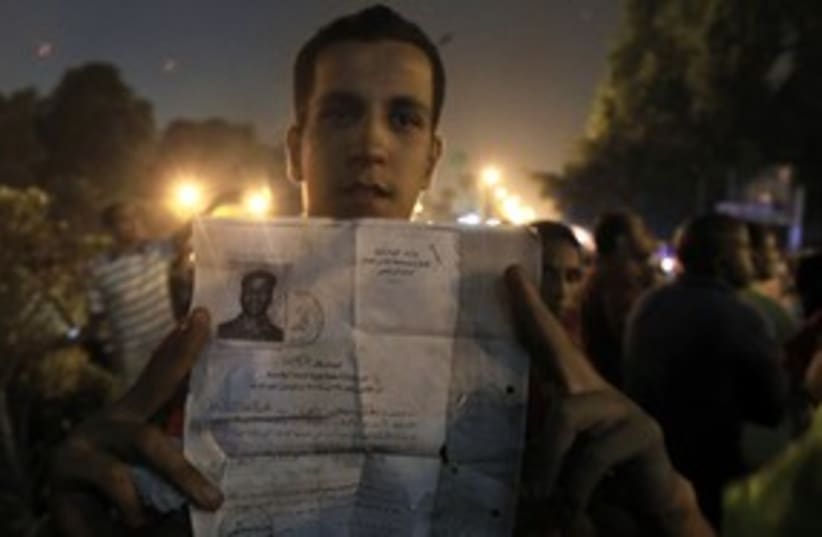 Egyptian protester holds documents from the Israeli embassy (photo credit: REUTERS)