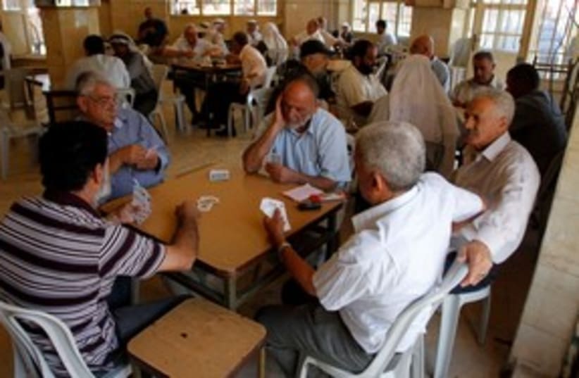 Palestinians playing cards in Ramallah cafe 311 (R) (photo credit: REUTERS/Mohamad Torokman)