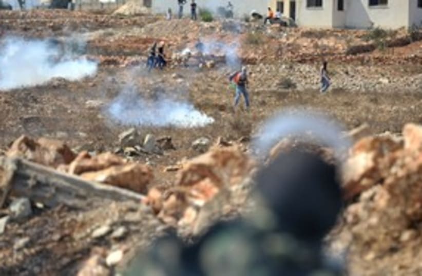 IDF tear gas fire at Palestinians throw stones in Nebi Salah (photo credit: IDF Spokesman)