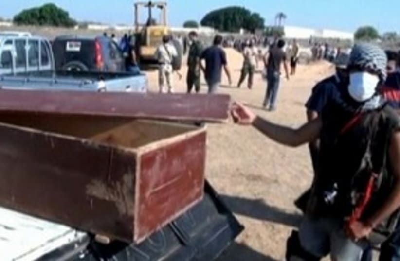 Libyan fighter displays coffin 311 (R) (photo credit: Reuters)