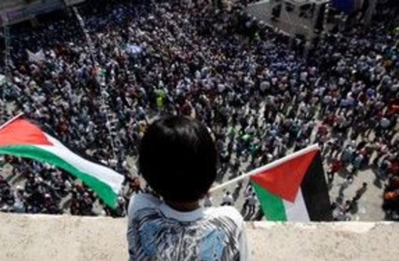 Palestinian boy looks over rally in Ramallah 311 (R) (photo credit: REUTERS/Darren Whiteside)