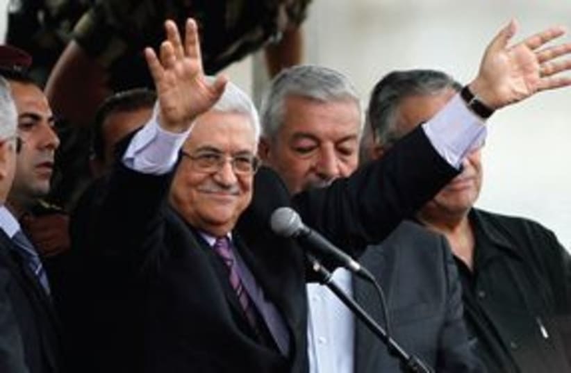 PA President Mahmoud Abbas waiving 311 (R) (photo credit: REUTERS)