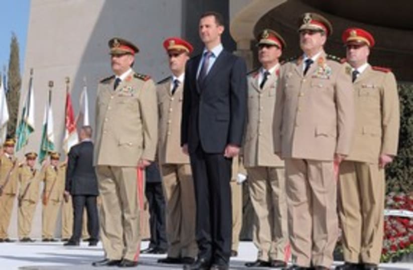 Syrian President Bashar Assad with his army generals 311 (R) (photo credit: Reuters)