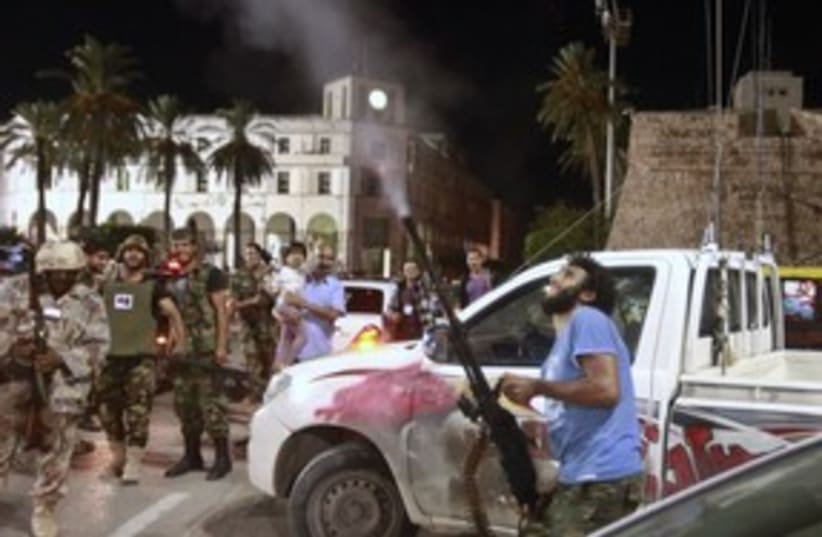 Libyan fires in air at Mo'tassim Gaddafi's capture_311 (photo credit: Reuters)
