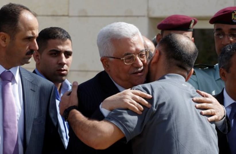 Abbas hugging newly released prisoner  R 465 (photo credit: ABED OMAR QUSINI/ REUTERS)