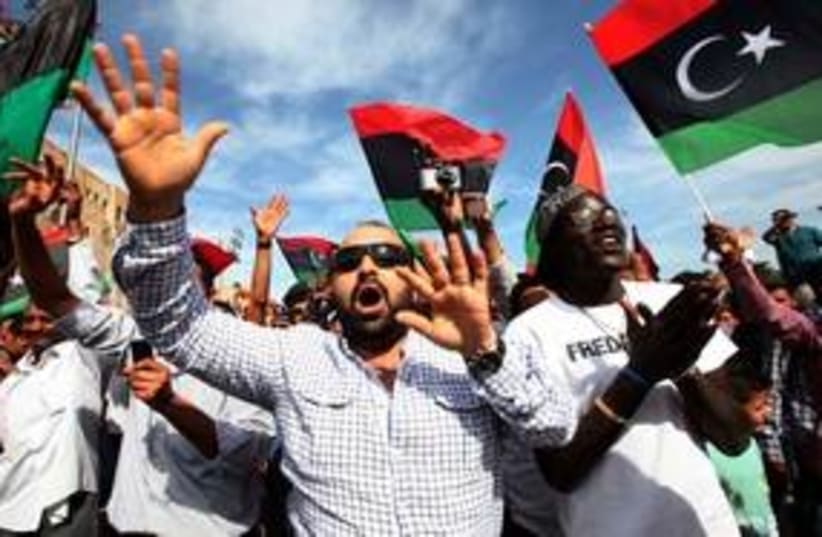 Libyans celebrate news of Muammar Gaddafi's death 311 (R) (photo credit: REUTERS/Ismail Zitouny)