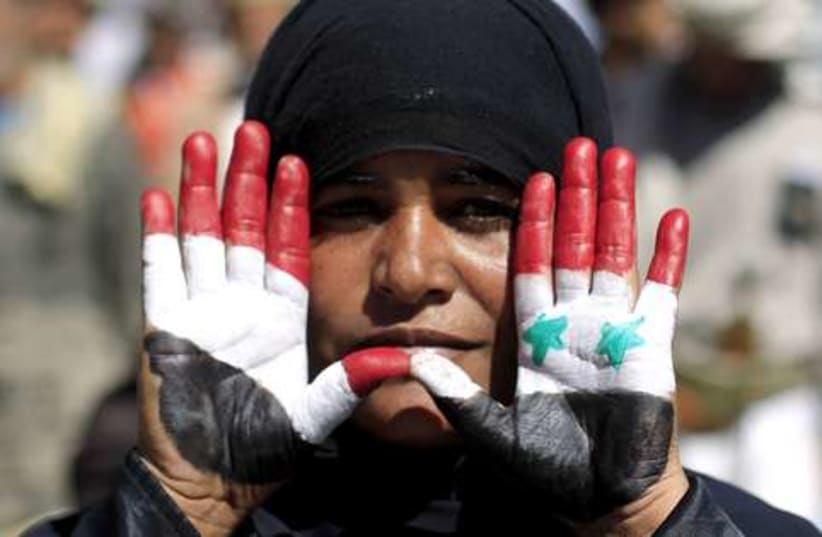 Yemen and Syria flags on hands 521 (photo credit: 	 REUTERS/Khaled Abdullah Ali Al Mahdi)