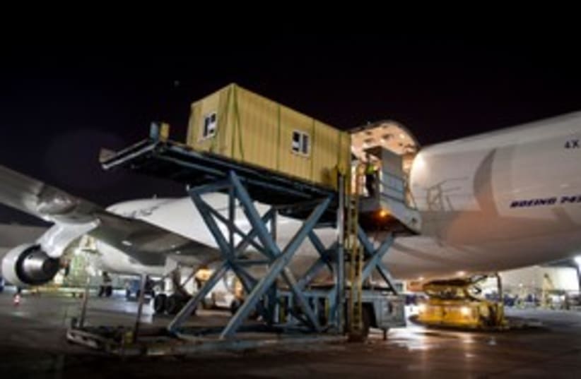 Prefabricated homes are loaded onto an ElAl cargo jet 311 (R (photo credit: REUTERS/ Nir Elias)