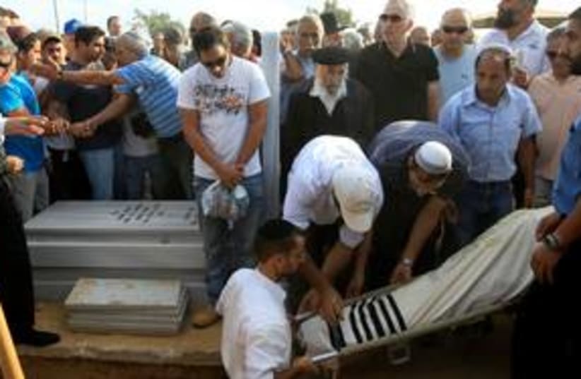 Funeral for rocket victim Moshe Ami 311  (R) (photo credit: REUTERS/Ronen Zvulun)